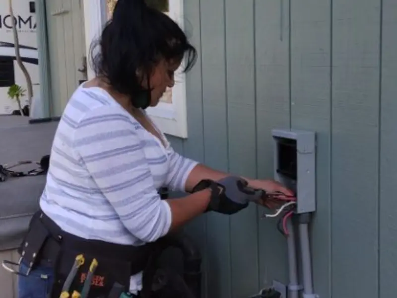 Licensed electrician wiring an exterior subpanel in Stockbridge